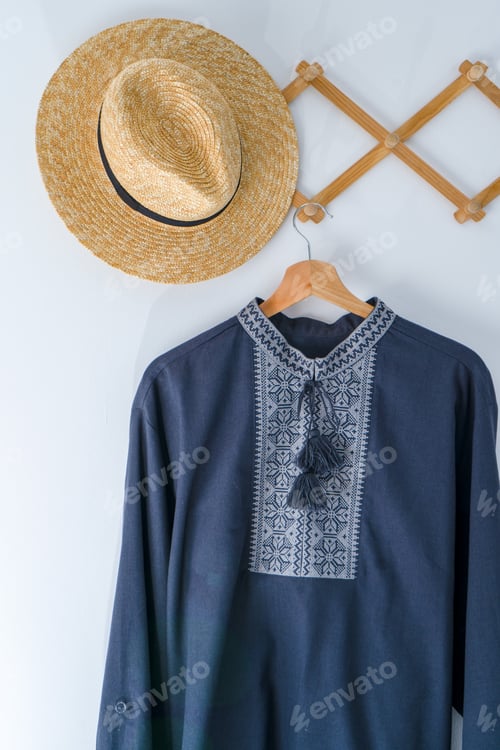 Preview: Ukrainian clothes embroidered man shirt. Blue gray and black threads background. Vyshyvanka is a