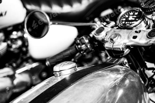Preview: Close-up grayscale shot of an old motorcycle control panel