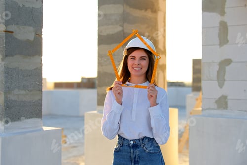 Preview: Smiling Construction Worker Holds Framing Square Outdoors