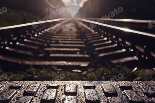 Preview: Low angle photo of rails and sleepers and pedastrin transition