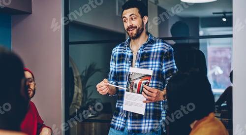 Preview: Cheerful adult employee making funny presentation to diverse colleagues in conference room