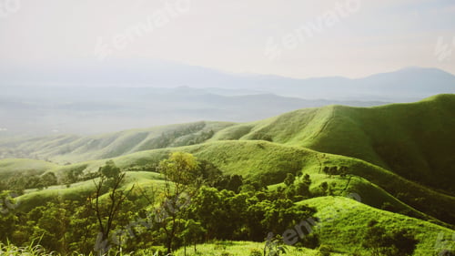 Preview: Rolling Green Hills Landscape with Trees and Cloudy Sky