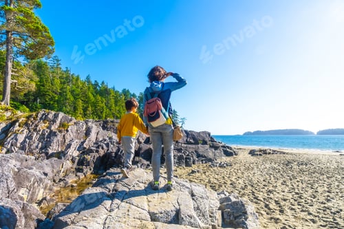 Preview: Mother and son exploring rocky coastline in tofino, vancouver island
