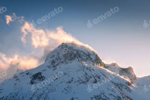 Preview: Golden wind sweeping over the snowy peak of the Omeshorn in Lech am Arlberg