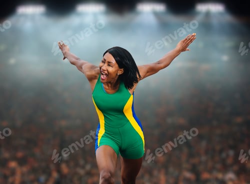 Preview: Young female athlete celebrating in front of stadium crowd