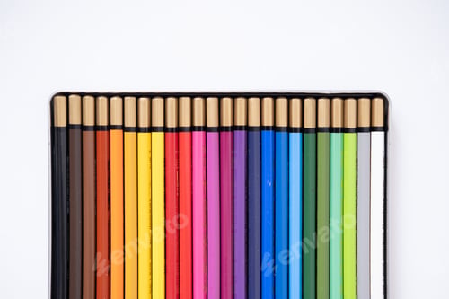Preview: Colored pencils in a box on a white background. Flat lay, top view.