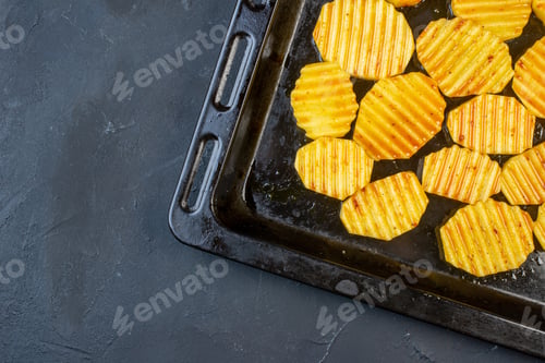 Preview: bottom half view tasty grilled potatoes on sheet pan on black background free space