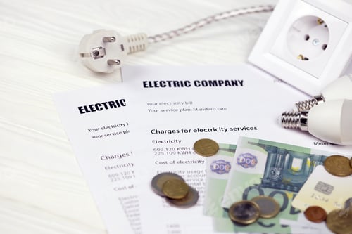 Preview: Calculator and Euro bills with pen on european electricity bill