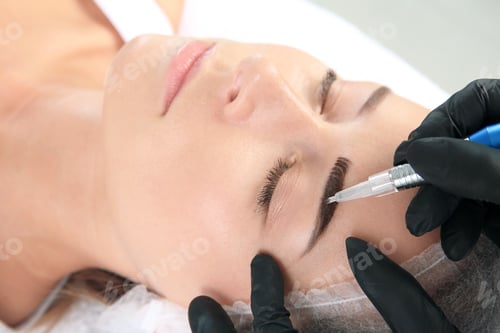 Preview: Young woman undergoing eyebrow correction procedure in salon
