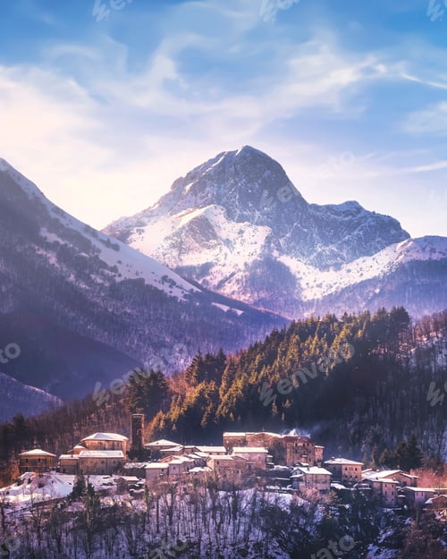 Preview: Winter view of Apuan Alps mountains and Nicciano snowy village. Garfagnana, Tuscany, Italy
