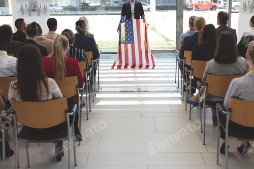 Preview: Mid section of male mixed race speaker speaks in a business seminar in office building