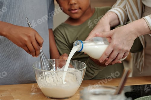 Preview: Family Mixing Batter Together during Baking Activity