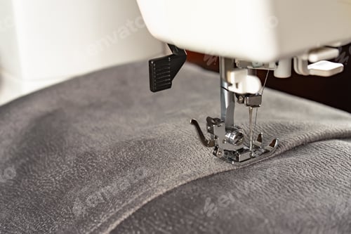 Preview: Modern sewing machine and gray fabric. Sewing process, handmade, hobby, DIY, business, repair