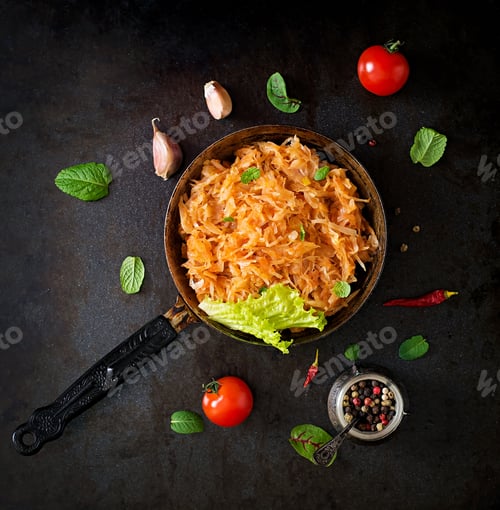 Preview: Stewed cabbage on the old wooden background in rustic style. Top view