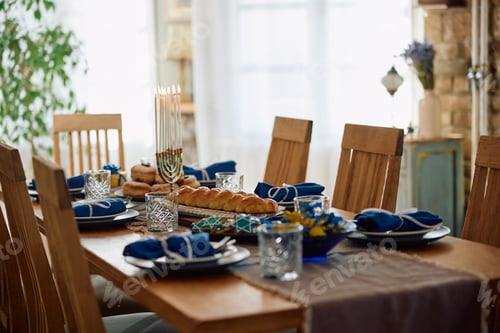 Preview: Hanukkah table setting ready for family meal at home.