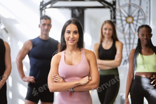 Preview: Fitness class with crossed arms in gym