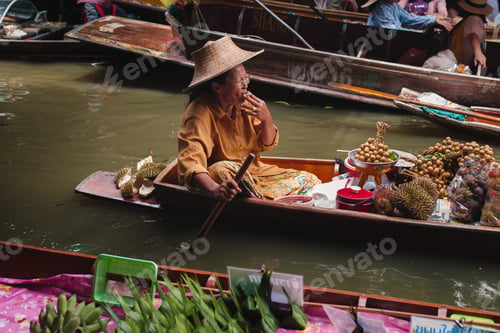 Preview: Asian senior woman smoking and sailing in boat