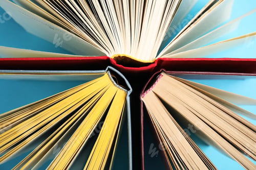 Preview: Hardcover books on light blue background, flat lay