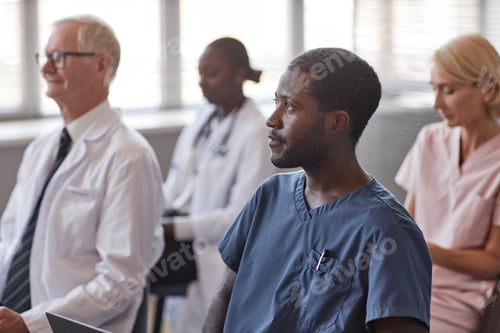 Preview: Black Man Listening to Colleagues Presentation in Conference Room