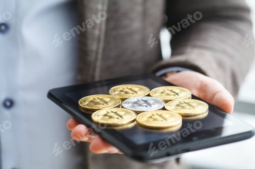 Preview: Business man pressing button bitcoin on tablet