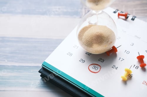 Preview: hourglass on a calendar, and flowing through the bulb of sandglass