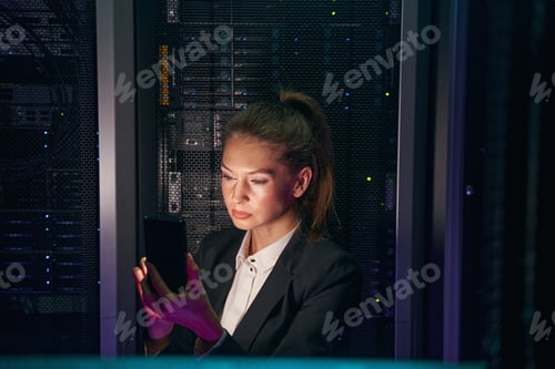 Preview: System administrator checking servers with cellphone in data center