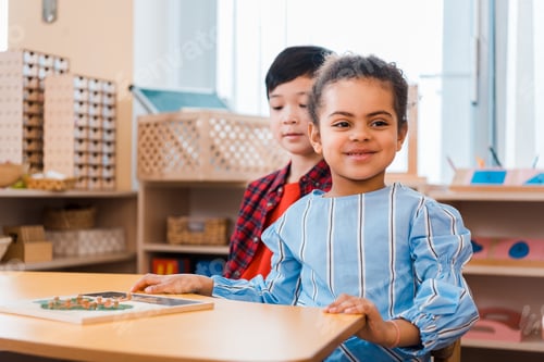 Preview: Kids with wooden game on table in montessori school