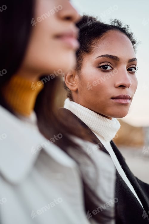 Preview: Close up beautiful African American girl thoughtfully looking in camera by the sea