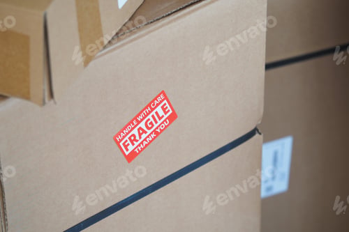 Preview: Boxes with fragile labels stacked for careful handling