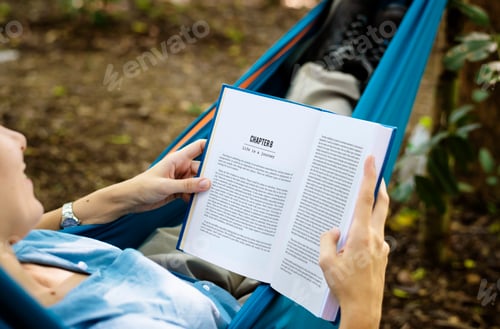 Preview: Woman reading a book in a hammock