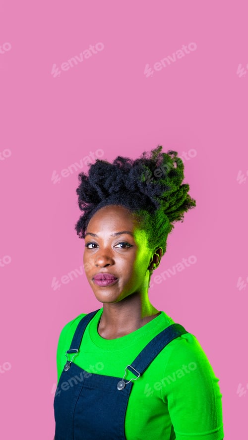 Preview: Studio portrait young black woman looking camera smiling isolated pink background