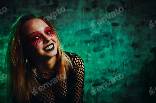 Preview: Female model in halloween outfit posing with on a red background. Gorgeous girl in clothes