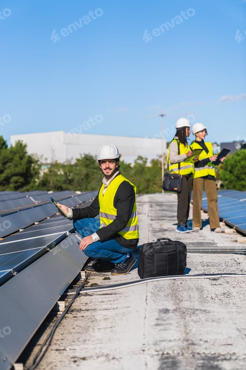 Preview: Engineers inspecting solar panels on rooftop for renewable energy