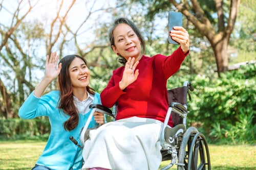 Preview: Asian grandmother in wheelchair with daughter is enjoying at the park in the morning