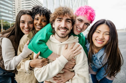 Preview: Portrait of diverse hipster young friends smiling at camera standing together