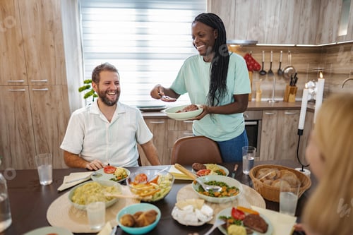 Preview: Joyful gathering at a cozy dining table with delicious food