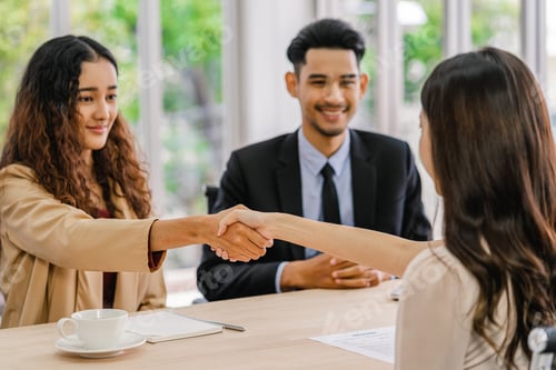 Preview: Closeup handshake after interview agreement between Young Asian woman