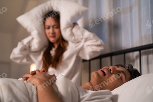Preview: Asian woman feel frustrated from husband snoring while sleep at night.