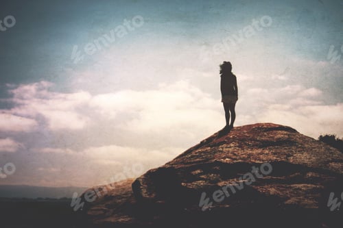 Preview: Low angle view of the silhouette of a millenial. Freedom.