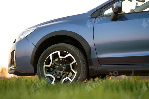 Preview: Close up of blue off road car on green grass. Traveling by auto, adventure in wildlife, expedition