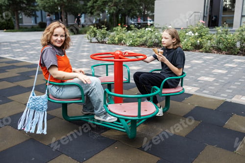 Preview: Portrait of a happy mother and son playing on playground and having fun. Summer park. Outdoors.