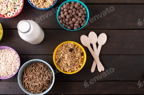 Preview: Overhead view of milk bottle by various breakfast cereals on table