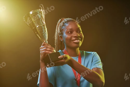 Preview: Female Athlete Holding Trophy