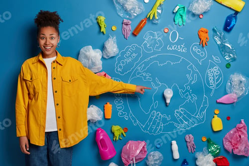 Preview: Positive dark skinned woman demonstrates her plan about cleaning Earth, points at ligh bulb in cente
