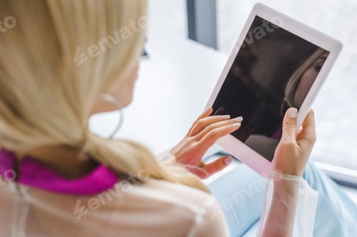 Preview: cropped view of woman using digital tablet with blank screen