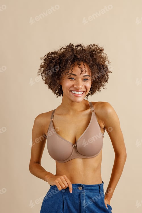 Preview: Attractive multiracial female posing at camera over beige background