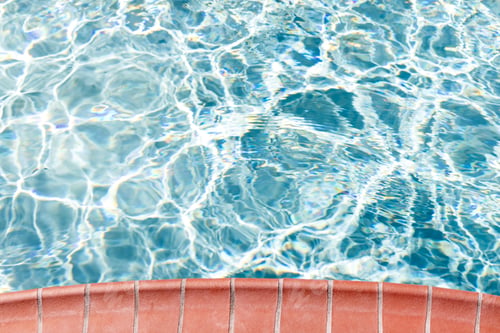 Preview: Poolside and blue water of pool