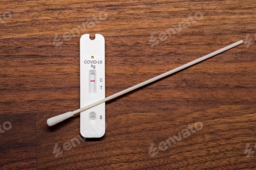 Preview: Negative result of the Covid-19 antigen rapid test in front of brown wooden background