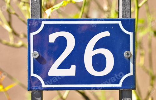 Preview: Closeup shot of a blue sign with the number 26 on the blurry background