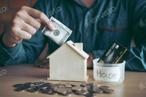Preview: Men are using banknotes in the home piggy bank with the idea of collecting money to buy a new house.